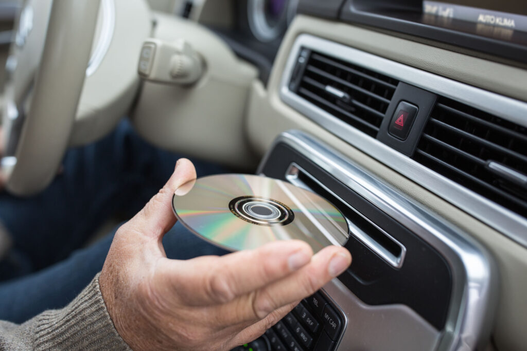 Man Playing Music In Hic Car Inserting Hi Fi Cd Into His Cd Re