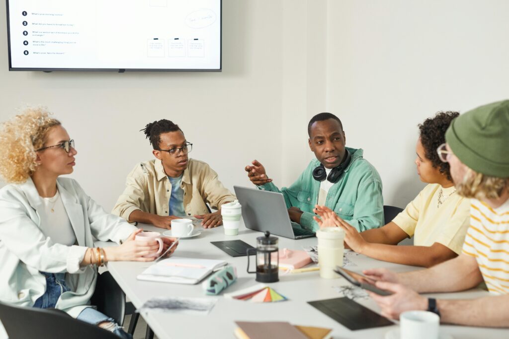 Colleagues exchanging tense glances across a conference table