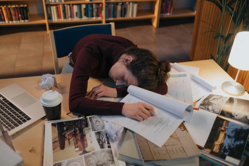 Tired employee slumped at a cluttered desk